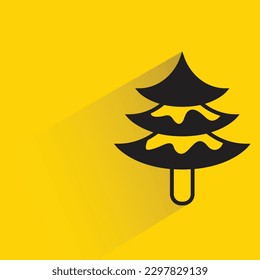Christmas tree with shadow on yellow background