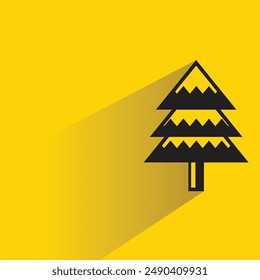 Christmas tree with shadow on yellow background