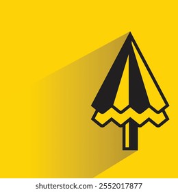 Christmas tree with shadow on yellow background