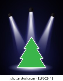 A Christmas tree shape in the spotlight with space for your text. EPS10 vector format.