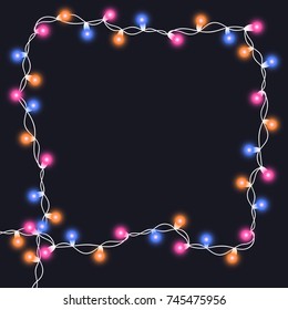 Christmas tree string garland in frame shape and text space isolated on dark background. Realistic Christmas, New Year party decorations with transparency. Light bulb decor. Lights border.