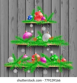 Christmas tree of three wooden shelves showcases with shadow on gray wooden panel wall background. Advertising holiday wood plank shelf store. Sale interior furniture