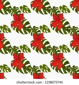 Christmas tropical pattern with monstera leaf and bow. Vector watercolor seamless background. Decoration on white backdrop. Hand drawn illustration.