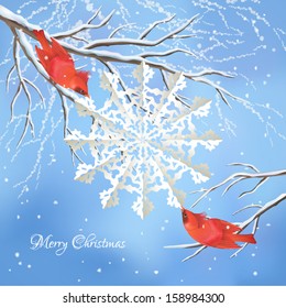 Christmas vector background with red birds waxwings, white snowflake cut from paper, snow-covered frozen tree branches, snowfall, text Merry Christmas on blue backdrop. Winter landscape greeting card