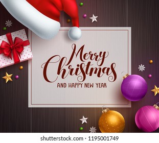 Christmas vector background template with merry christmas greeting text in white space and colorful elements like santa hat, gift and balls in wood texture background. Vector illustration.
