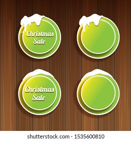 Christmas vector green glossy buttons set isolated on wooden background. web green christmas sale buttons with snow, ice border