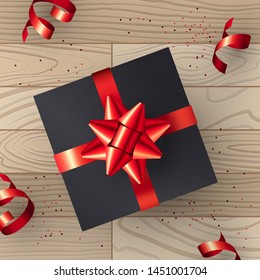 Christmas vector illustration with present box on a wooden background in realistic style