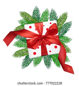 Christmas vector realism mesh gift box with a red bow on christmas tree branches on isolated white background