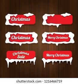 Christmas vector red glossy buttons set isolated on vintaeg wooden sign background. web red christmas sale buttons with snow, ice border