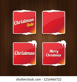 Christmas vector red glossy buttons set isolated on vintaeg wooden sign background. web red christmas sale buttons with snow, ice border