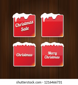Christmas vector red glossy buttons set isolated on vintaeg wooden sign background. web red christmas sale buttons with snow, ice border