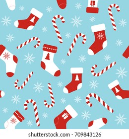 Christmas vector seamless blue pattern with candy canes, christmas socks and snowflakes. Background for wrapping paper, fabric print, greeting cards design