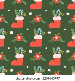 Christmas vector seamless pattern, boots with decorations, berries and sweets on green background.