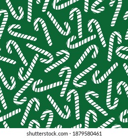 Christmas vector seamless pattern with lollipops . Green background. background for wrapping paper, fabric printing, greeting card design