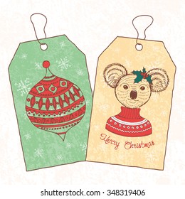 Christmas vintage tags. Hand drawn koala dressed up in sweater. Vector illustration.