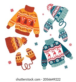 Christmas warm clothes set.Flat cartoon different knitwear.Holiday cute sweaters, hats and mittens with scandinavian patterns.Isolated vector illustration.Prefect for greeting cards,icons,posters.