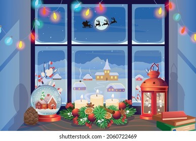 Christmas window with snow glass ball, Christmas wreath, Red Lantern and winter landscape. Facades of houses in winter at night.Village landscape outside the window. Merry christmas greeting card.