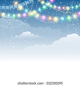Christmas winter background with multicolored electric garland and decorations and blue clouds sky