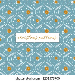 Christmas winter pattern with colorful oranges, firs and snowflakes on blue ice background