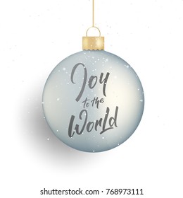 Christmas. Winter seasonal script lettering Joy to the World and realistic Christmas ball and snow