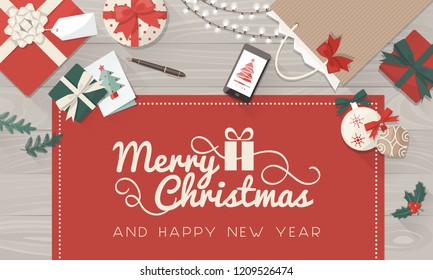 Christmas wishes and table with gifts, decorations and smartphone