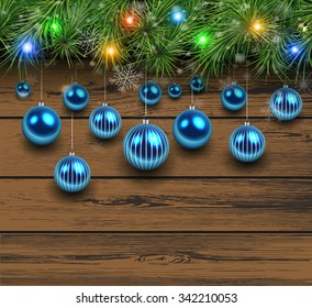 Christmas wooden background with fir branches and balls. Vector illustration. 