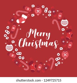 Christmas wreath with candy, ball, cotton branch, socks and snowflakes on red background. Perfect for greeting cards.
