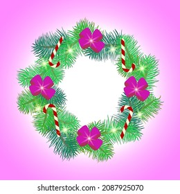 The Christmas wreath is decorated with a purple bow and New Year's candies on a pink background.