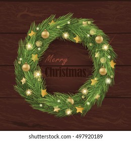 Christmas wreath with gold elements on the wood background