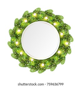 Christmas wreath made of green pine branches with light bulbs string and shining snowfkakes and round place for text. Fir tree wreath isolated on white
