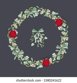 
Christmas wreath made of mistletoe branches with bows and toys. Beautiful red balls and green bows.