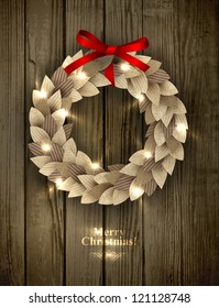 Christmas wreath made of paper leaves in eco country style decorated with red bow and sparkles