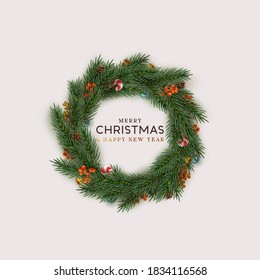 Christmas wreath realistic pine branches. Decorative design elements of berries, candy cane, bauble balls. Xmas decorate. Holiday background. Round frame made of natural winter decor things. Flat lay.