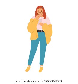A chubby girl posing while drinking. A girl wearing glasses, a pink t-shirt, a yellow fleece jacket, blue pants, a white sock with blue stripes, and yellow sneakers.