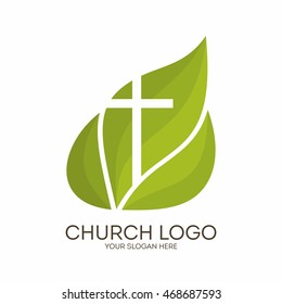 Church logo. Christian symbols. Cross on a background of green leaves