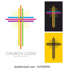 Church logo. Christian symbols. The cross of Jesus, multicolored stripes and glowing rays.