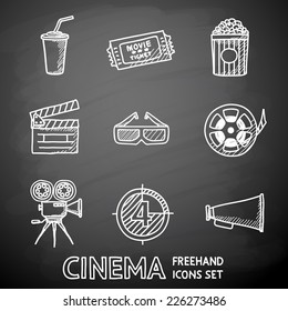 Cinema (movie) painted on black chalkboard icons set with - cinema projector, film strip, 3D glasses, clapboard, popcorn in a striped tub, cinema ticket, glass of drink.