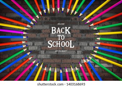 Circle of colored pencils and lettering back to school on vintage brick wall background. Banner on the topic of education. Vector illustration