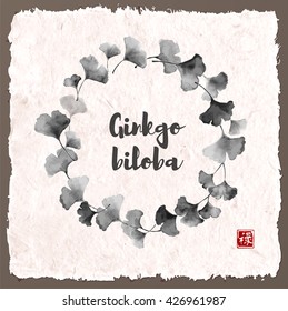 Circle of ginkgo biloba on vintage background. Traditional Japanese ink painting sumi-e. Contains hieroglyph - well-being