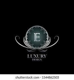 Circle Luxury Logo Letter E. Elegant logo design concept letter  E on silver circle  frame with floral element for boutique, hotel, fashion and more brands.