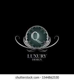 Circle Luxury Logo Letter Q. Elegant logo design concept letter Q on silver circle  frame with floral element for boutique, hotel, fashion and more brands.