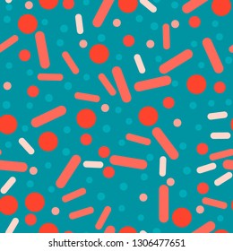 Circles and ovals - seamless pattern. Small and large circles and ovals of coral shades are randomly scattered on a bluish background. It looks like a pill or bacteria.