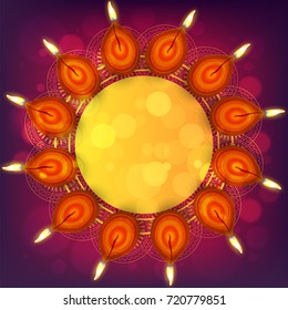 Circular Frame decorated with illuminated Oil Lamps for Diwali celebration.