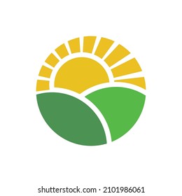 Circular Logo Concept Of Green Field And The Sunrise With Shiny Light