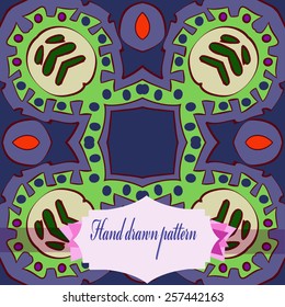 Circular pattern of colored floral motif, label on a pale blue    background. Hand drawn.