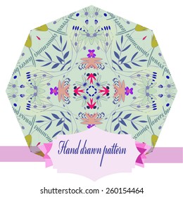 Circular pattern of colored floral motif, branches, leaves, label. Hand drawn.