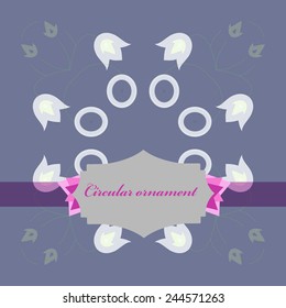 Circular  pattern of colored floral motifs, label   on a  pale blue  background. 