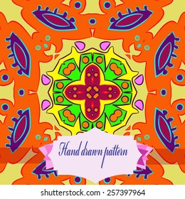 Circular pattern of floral motif, label on a pale yellow  background. Hand drawn. 