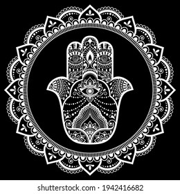 Circular pattern in form of mandala for Henna, Mehndi, tattoo, decoration. Decorative ornament in oriental style with Hamsa hand drawn symbol. White design on black background.