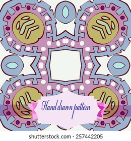 Circular pattern of pale colored  floral motif, label on a white    background. Hand drawn.